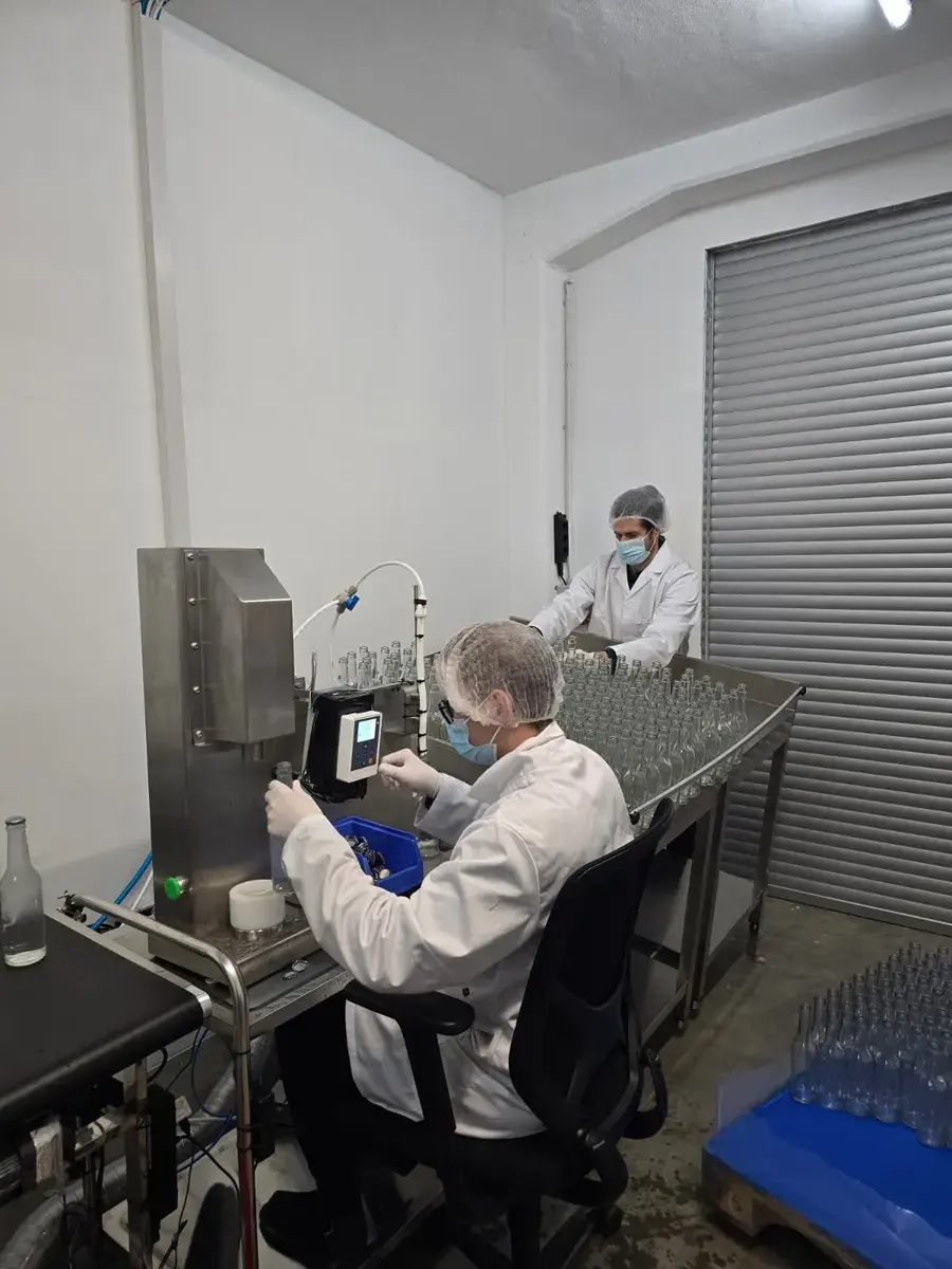Team members monitoring the filling equipment